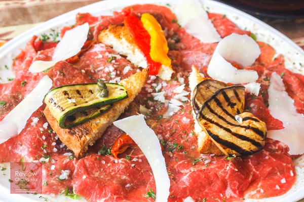 Beef Carpaccio on salad with grilled vegetable and parmesan cheese